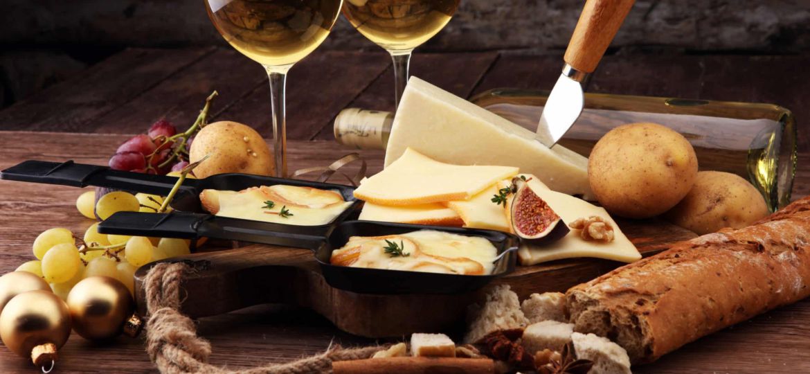 Delicious traditional Swiss melted raclette cheese on diced boiled or baked potato served in individual skillets.